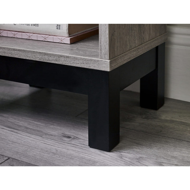 Wooden coffee table with black legs on a wooden floor
