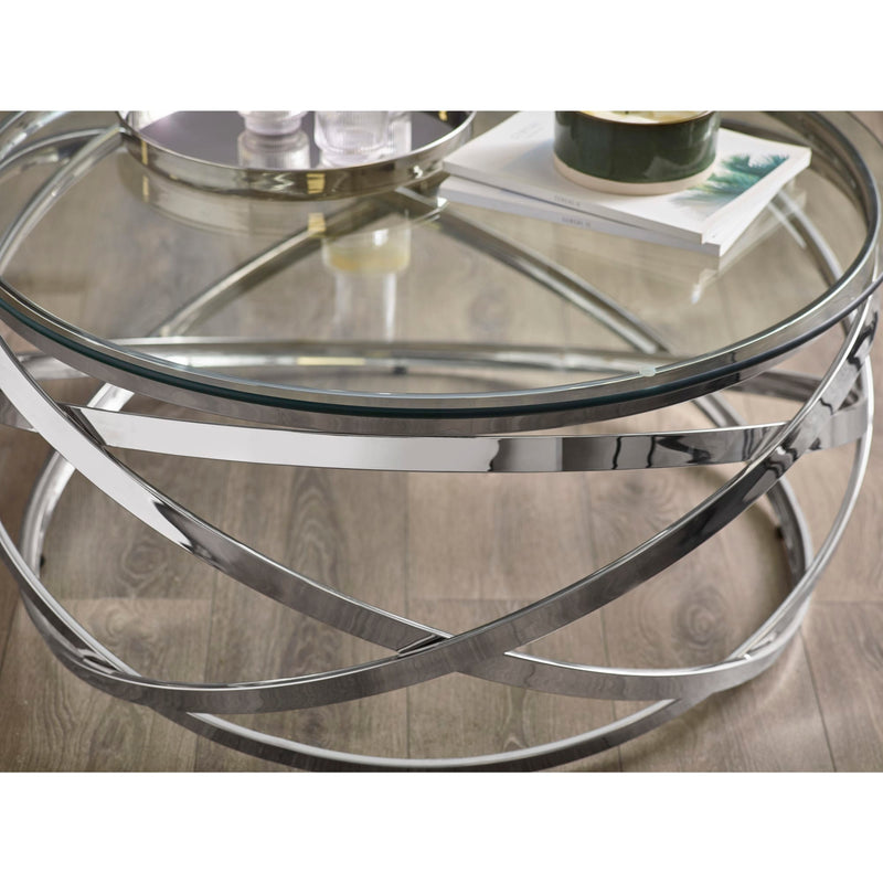 Round glass coffee table with metal frame on a wooden floor