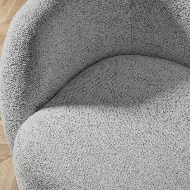 Close-up of a textured gray chair on a wooden floor
