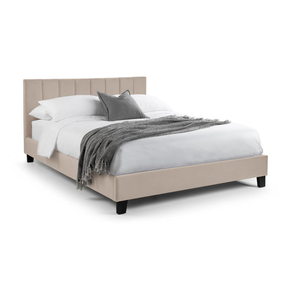 Beige bed with white bedding and gray blanket on a white background