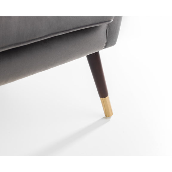 Close-up of a gray sofa with a dark brown leg and gold tip on a white background