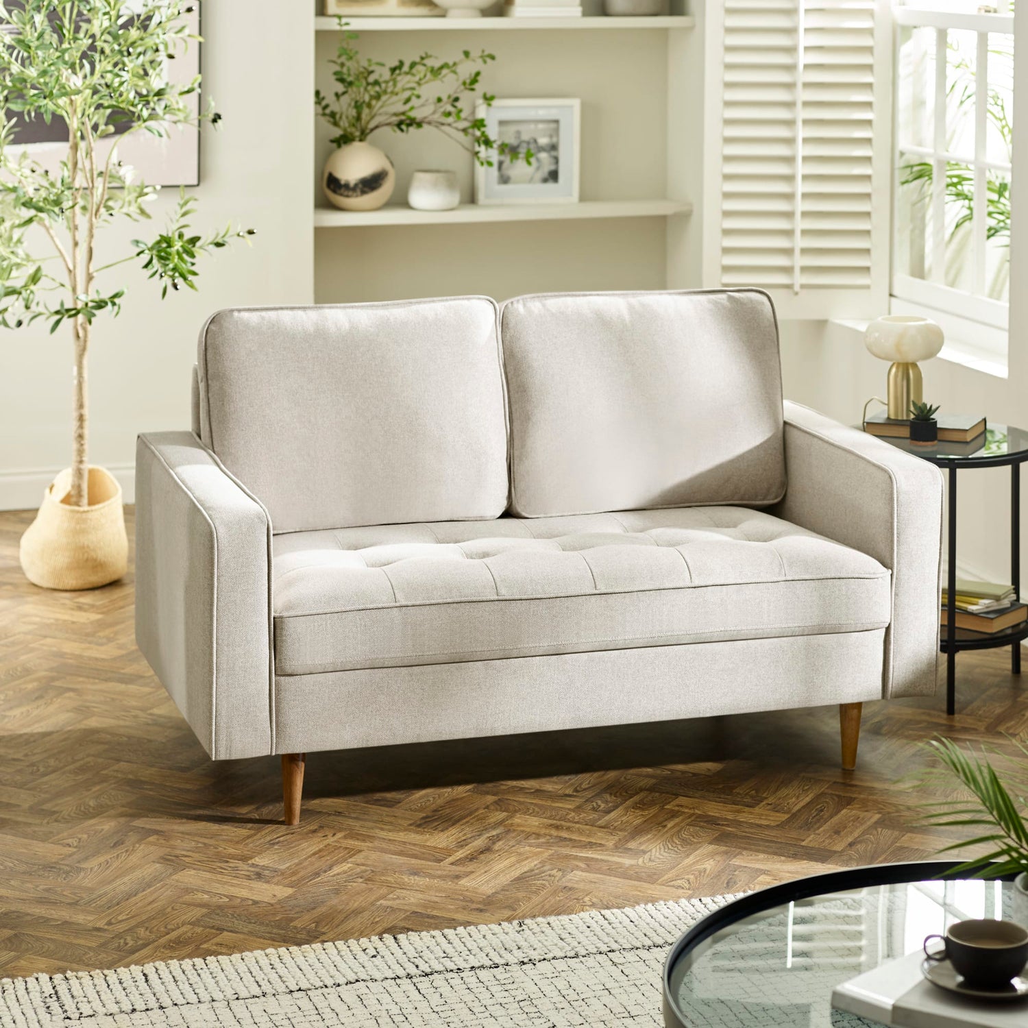 Light gray sofa in a living room setting with decor elements.