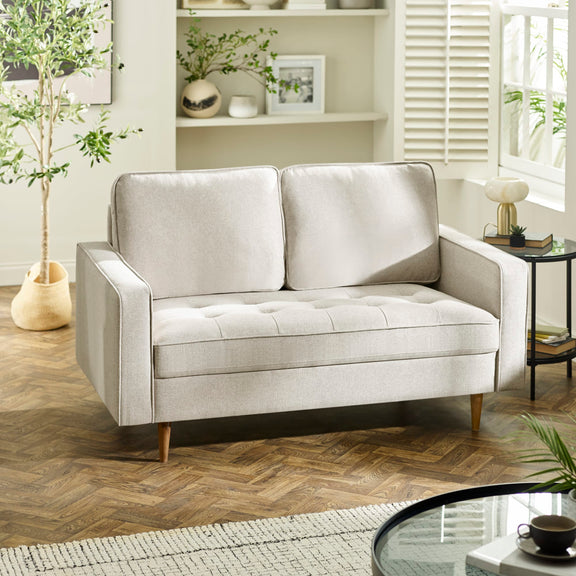 Light gray sofa in a living room setting with decor elements.