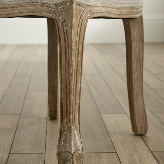 Close-up of a wooden chair leg on a wooden floor