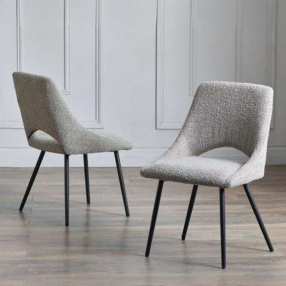 Two gray textured chairs with black legs on a wooden floor.