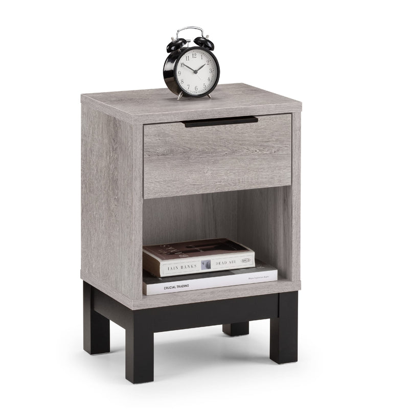 Gray wooden nightstand with a drawer, books, and an alarm clock on a white background