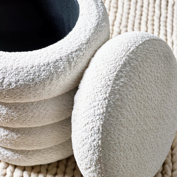 Textured stone-like bowls stacked on a textured surface