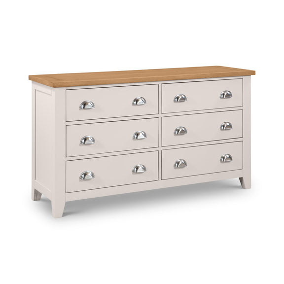 White dresser with six drawers and a wooden top on a white background