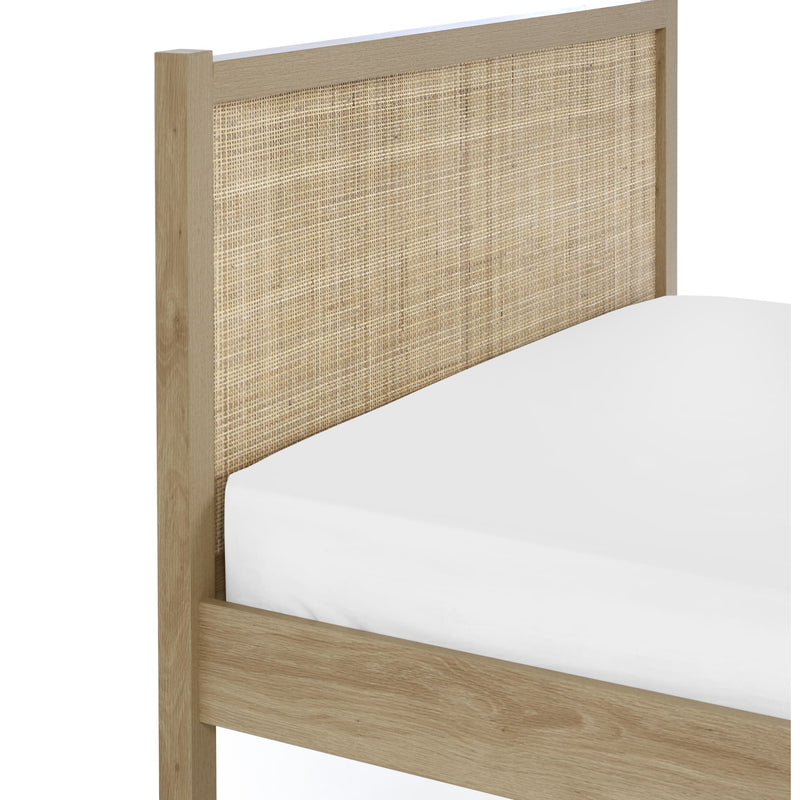 Wooden bed frame with wicker headboard on a white background