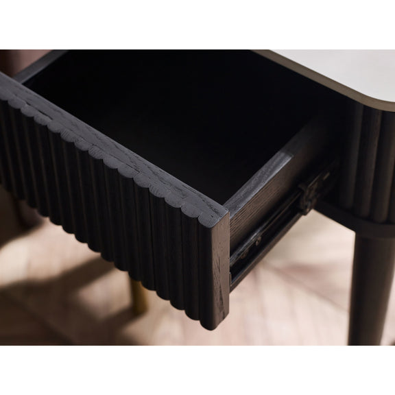 Wooden drawer with a ribbed texture on a light wooden floor