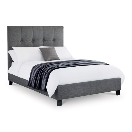 Gray upholstered bed with white bedding on a white background