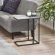 Small side table with decorative items next to a gray sofa in a living room.