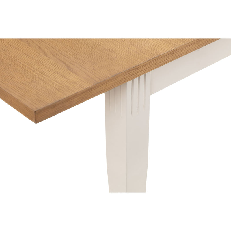 Wooden table corner with white base on a white background