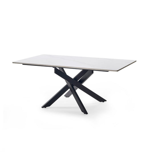 Modern dining table with a white top and black metal legs on a white background