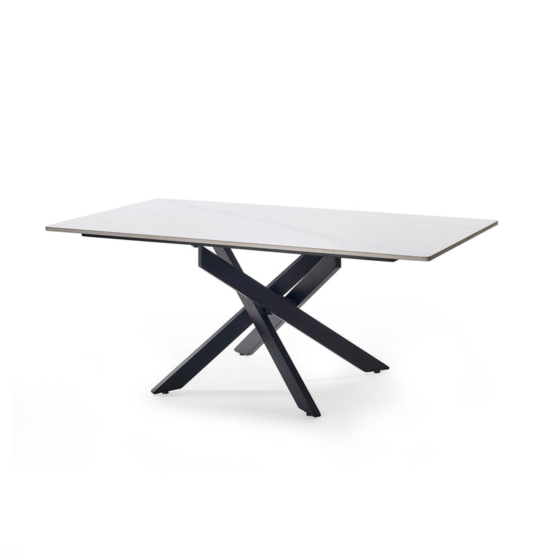 Modern dining table with a white top and black metal legs on a white background