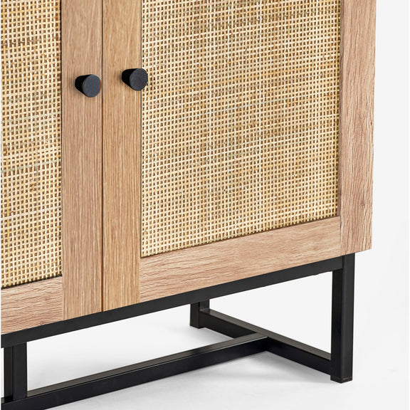 Wooden cabinet with rattan doors and black metal legs on a white background