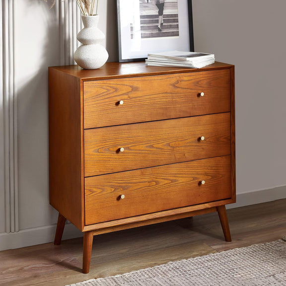 Wooden dresser with three drawers in a room setting