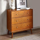 Wooden dresser with three drawers in a room setting
