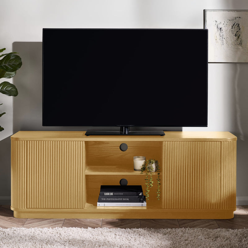 Wooden TV stand with a television on top, books, and decorative items in a room.