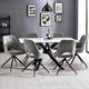 Dining room with a round table and gray chairs against a gray brick wall.