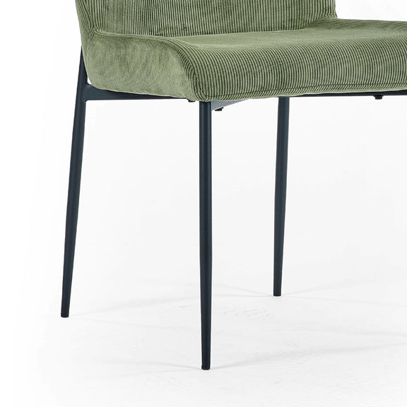 Green upholstered chair with black metal legs on a white background