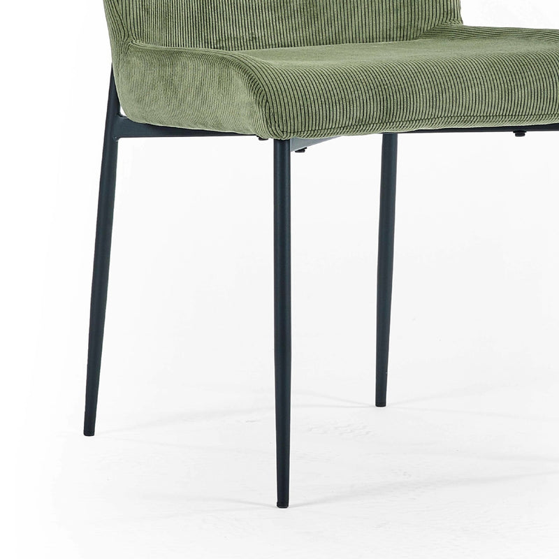 Green upholstered chair with black metal legs on a white background