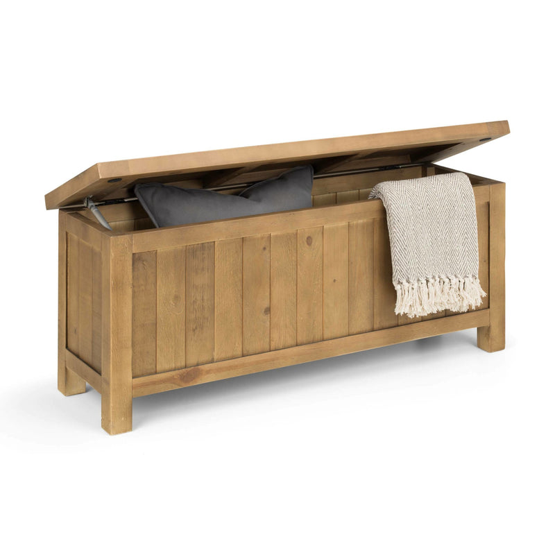 Wooden storage bench with a blanket and pillow on a white background