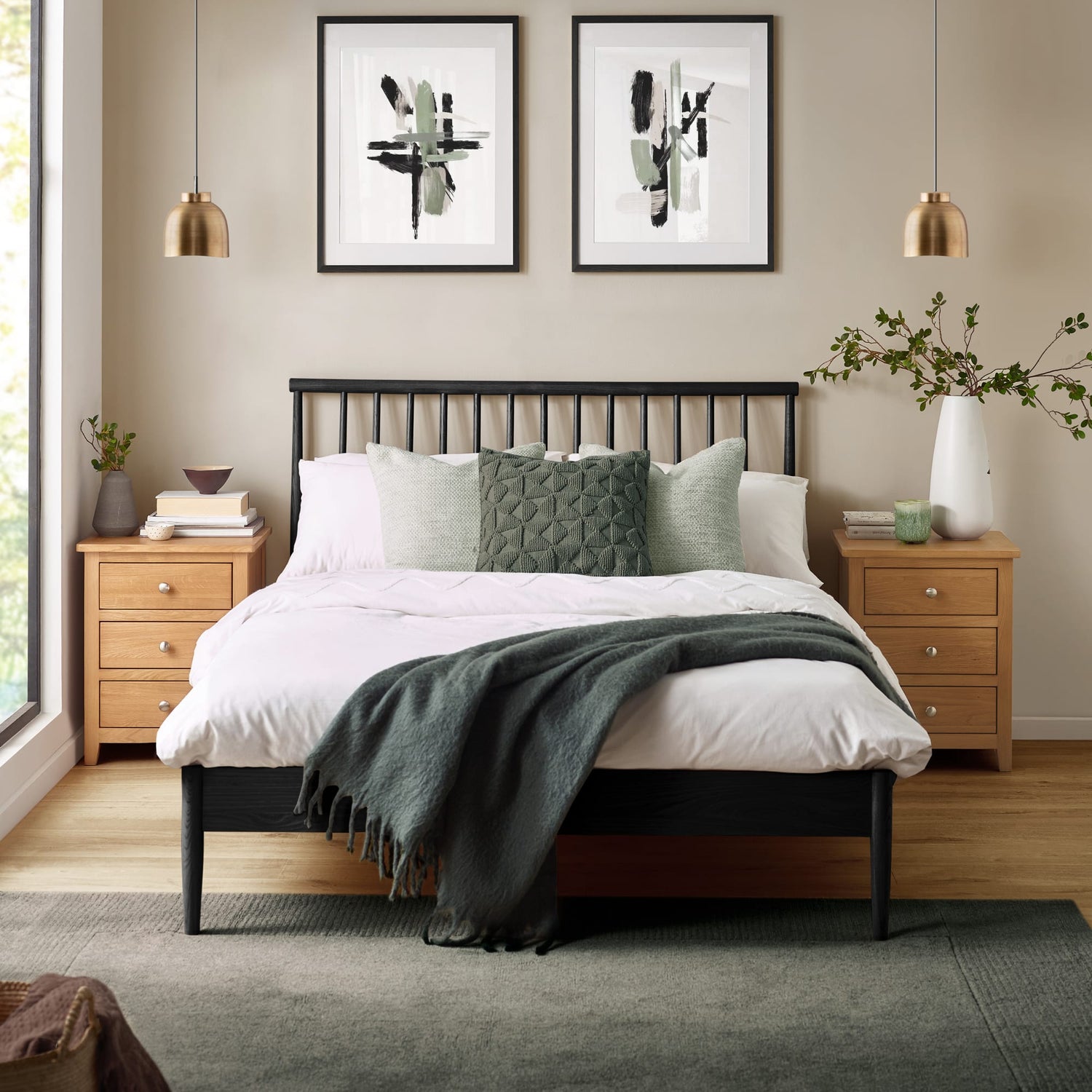 Neatly made bed with decorative pillows and a blanket in a bedroom setting.