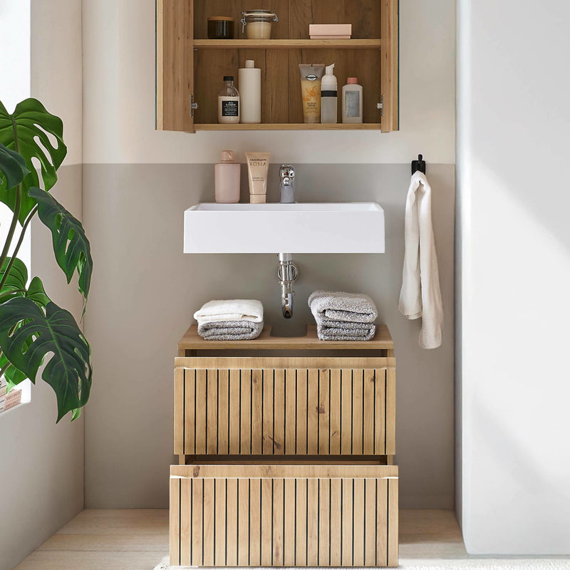 Bathroom with wooden vanity, sink, and shelves with toiletries.