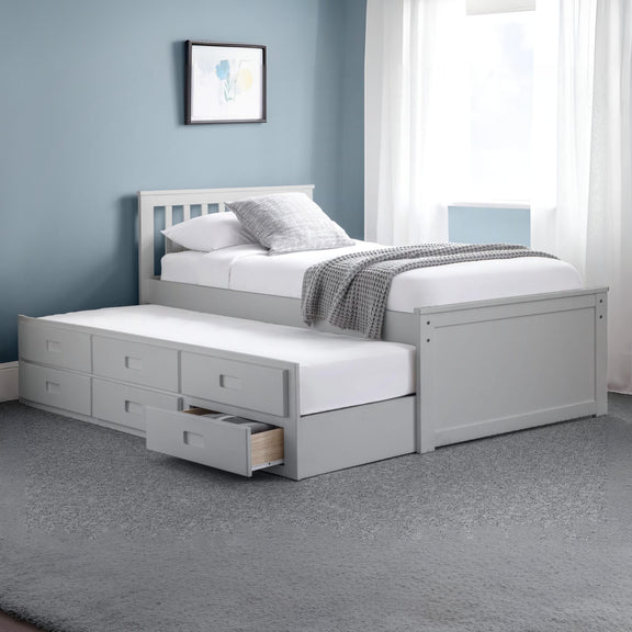 Gray bed with storage drawers in a bedroom setting