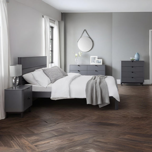 Modern bedroom with gray furniture and wooden flooring
