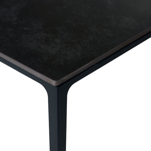 Black rectangular table with a textured surface on a white background