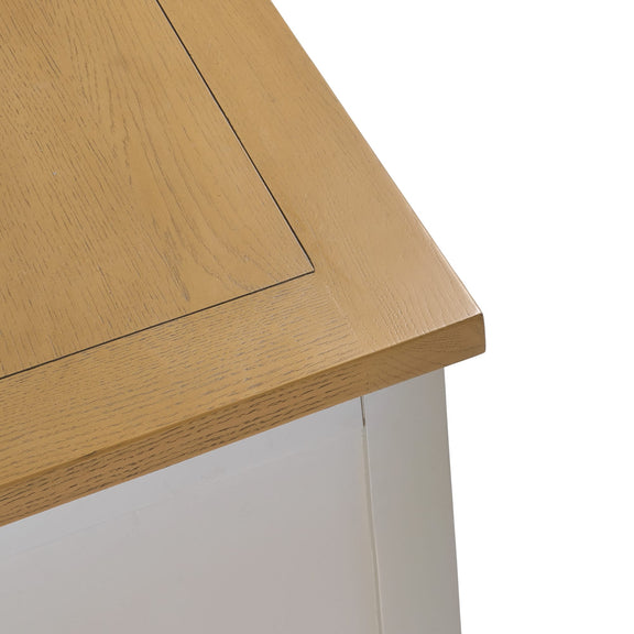 Close-up of a wooden desk corner with a white base