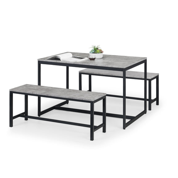Dining table and benches set with gray concrete top and black metal frame on a white background