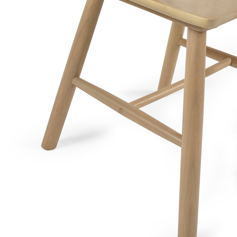 Close-up of a wooden chair leg on a white background
