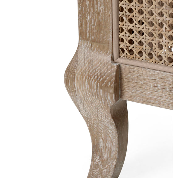Close-up of a wooden leg with intricate carvings on a white background