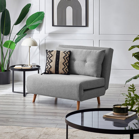 Gray sofa with decorative pillows in a modern living room setting.