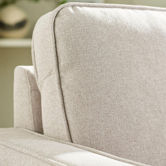 Close-up of a textured beige sofa cushion