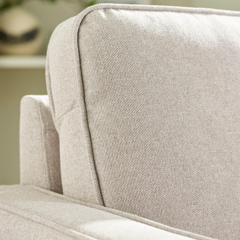 Close-up of a textured beige sofa cushion