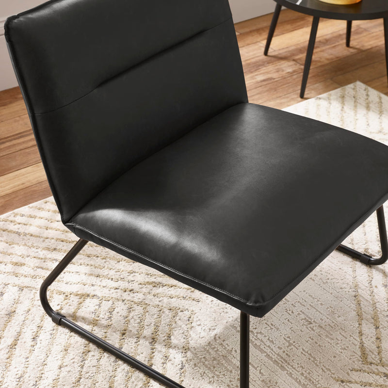 Black leather chair on a textured rug with a blurred background