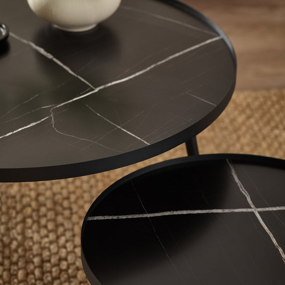 Round black marble table with a textured surface
