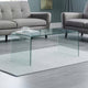 Glass coffee table in a living room with gray sofa and rug