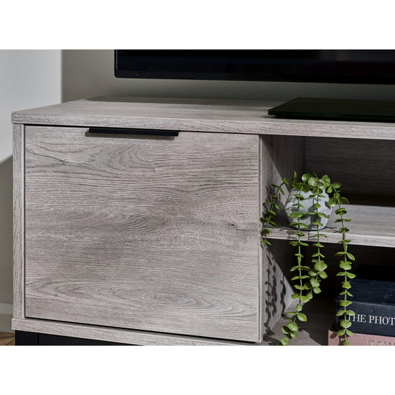 Wooden entertainment console with a drawer and plant decoration.