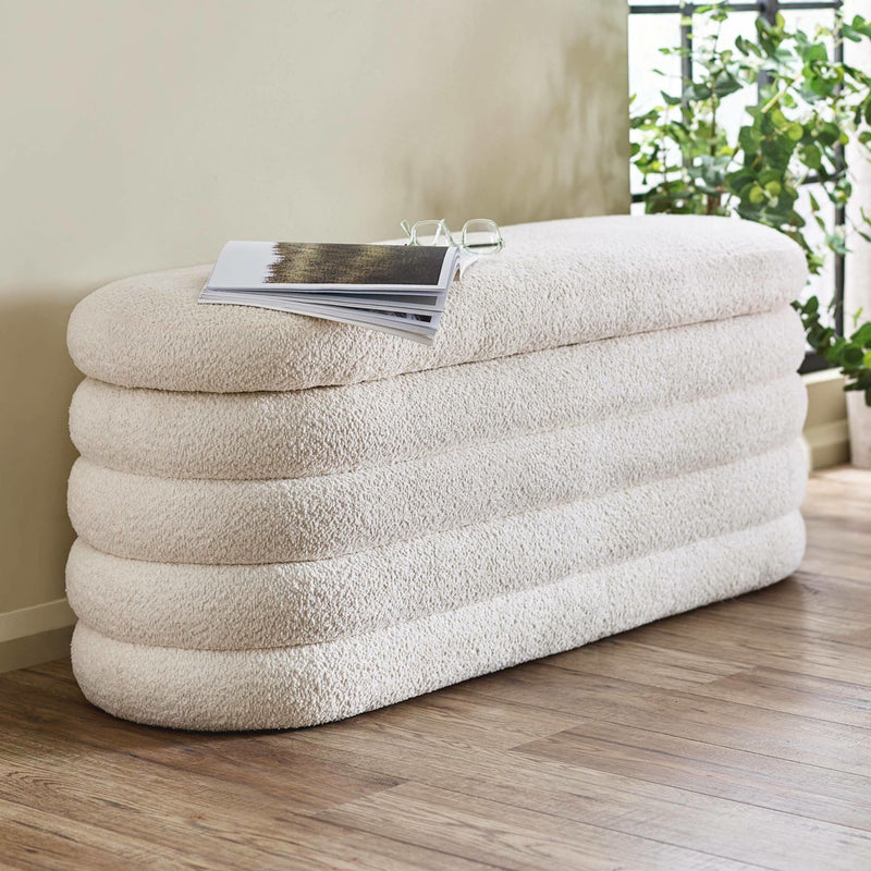 Inflatable air bed with a magazine on top in a room with plants
