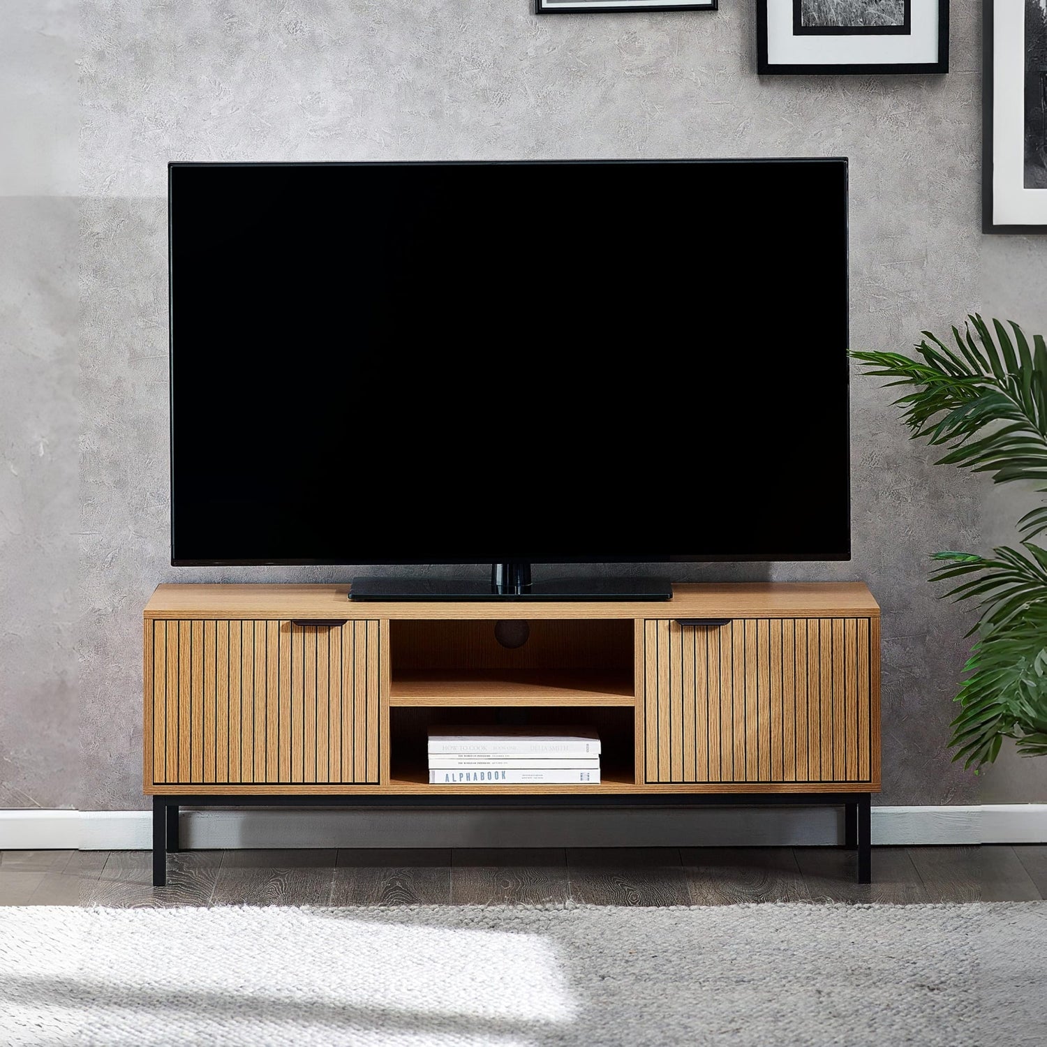 Wooden TV stand with a television on a gray wall background