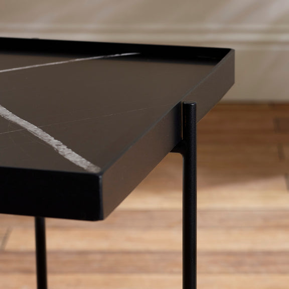 Close-up of a black marble table with a blurred background