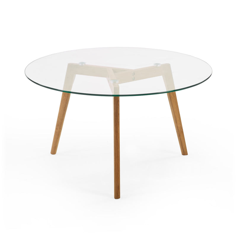 Round glass table with wooden legs on a white background
