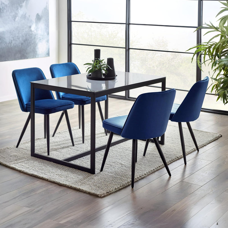 Dining table set with blue chairs in a modern room.