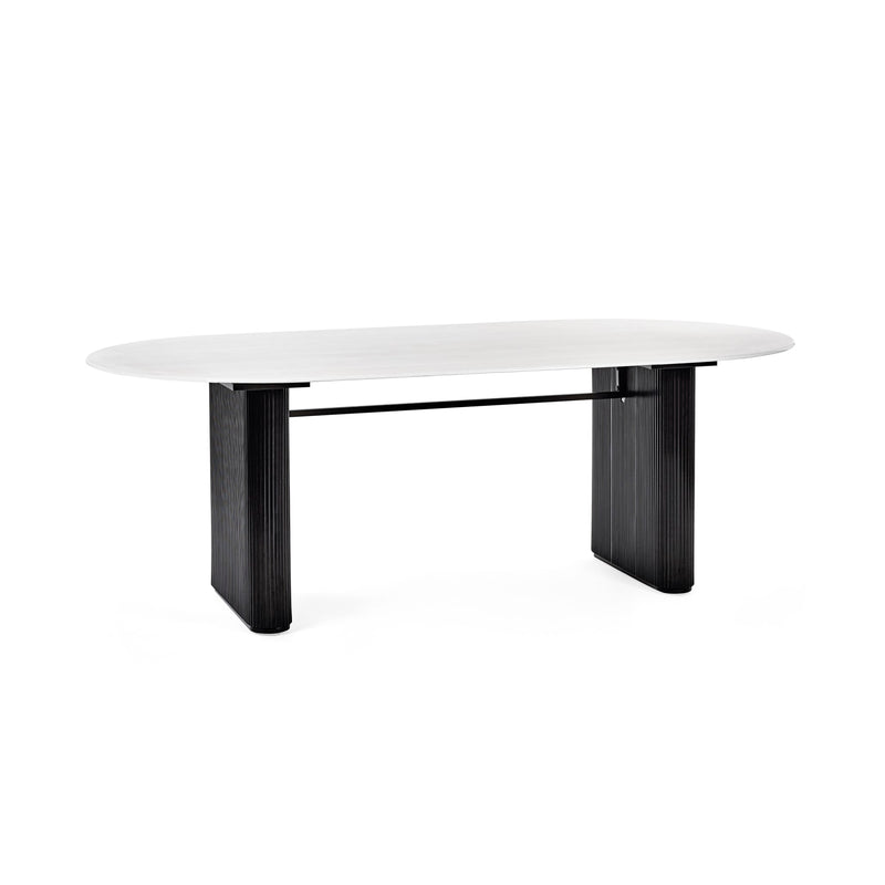 Modern dining table with white top and black legs on a white background