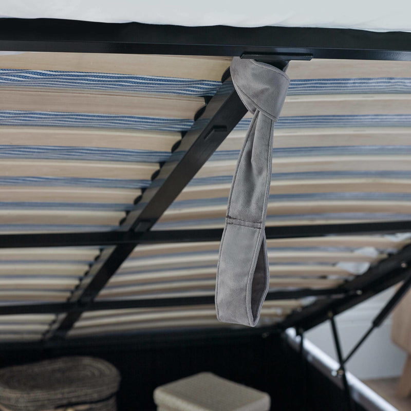 Gray tie hanging from a black metal frame with striped fabric background